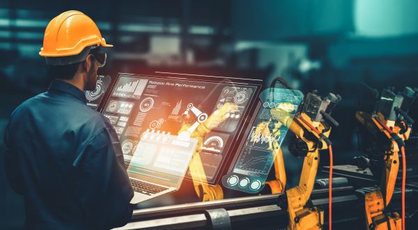 Manufacturing employees operating industrial equipment, facing daily security challenges that impact data protection and operational safety without proper training. 